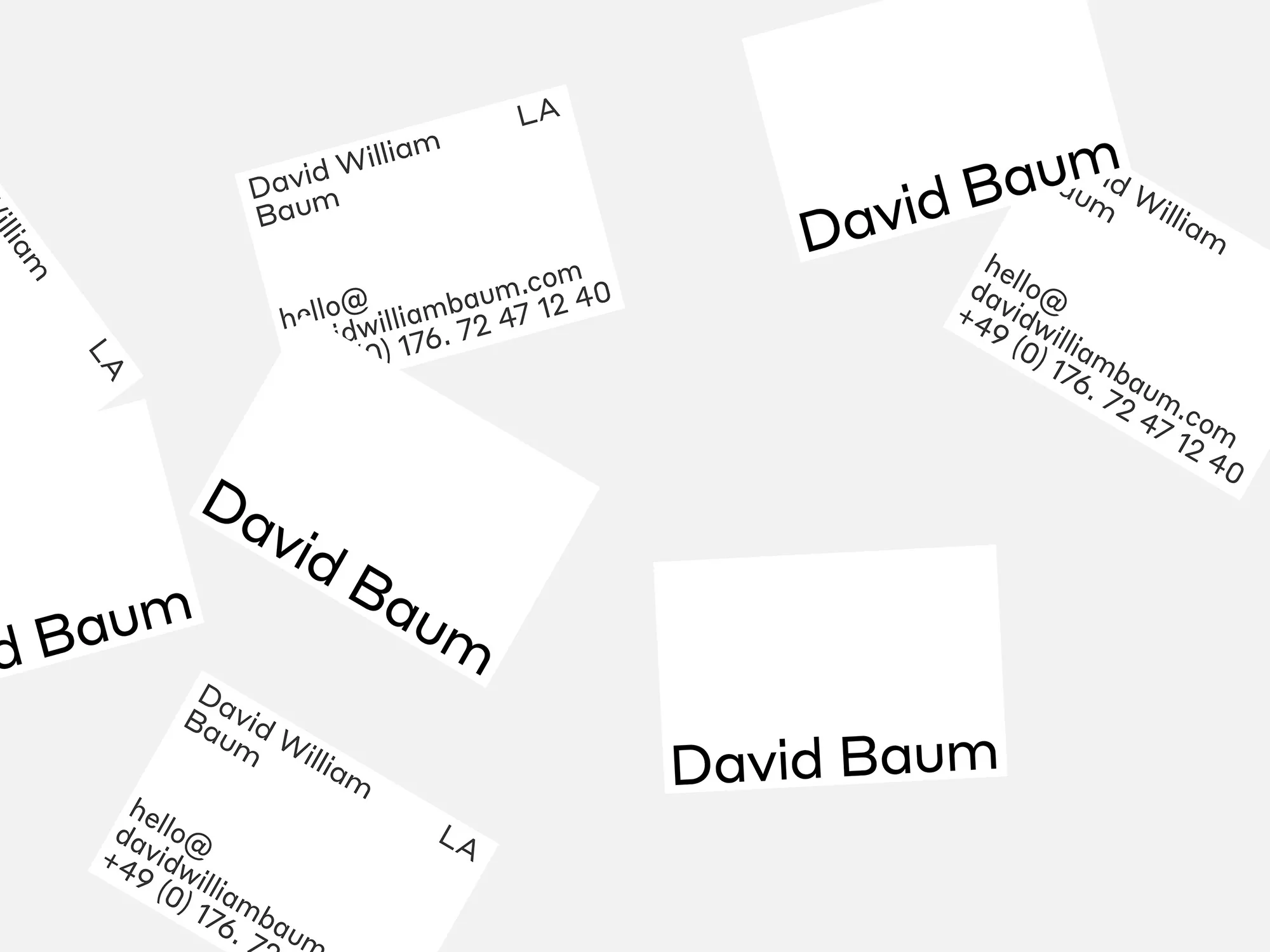 Scattered white business cards with black text featuring the name 'David Baum,' email, and phone number on a light gray background.