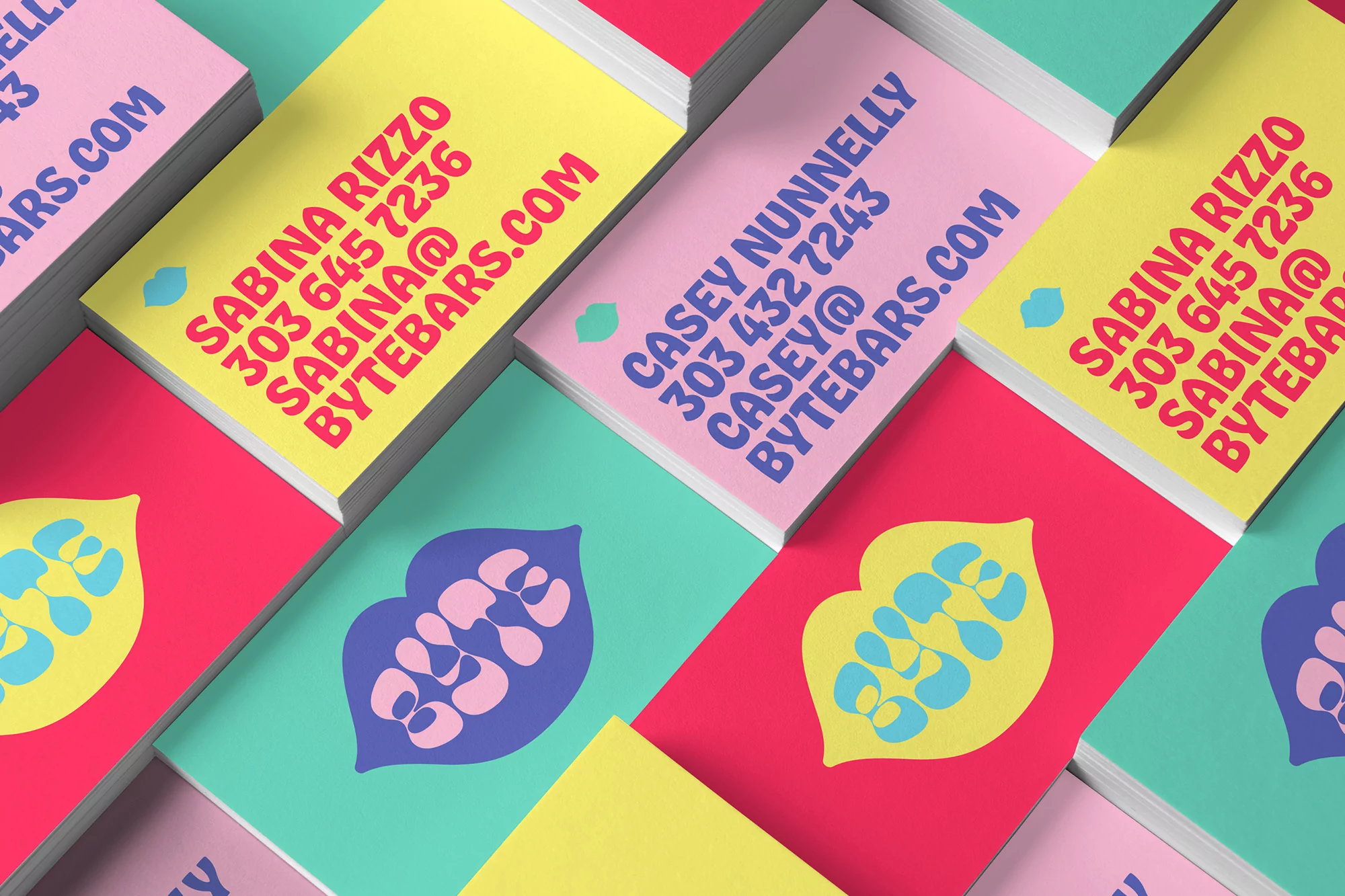 Stacks of colorful business cards featuring company names and contact information displayed in bright and vibrant colors.