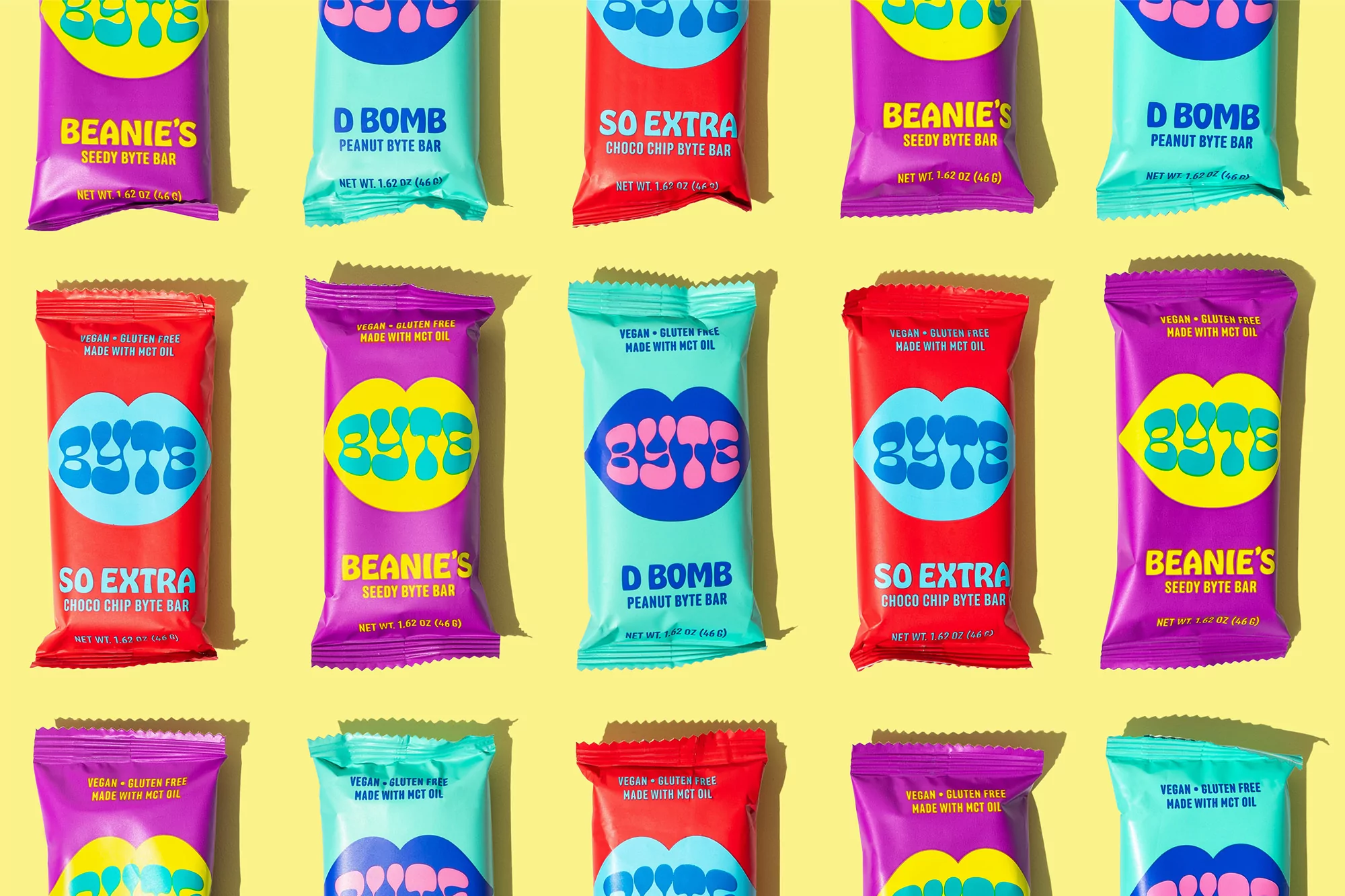 Multiple colorful Byte bars in purple, teal, and red on a yellow backdrop, displayed in a grid pattern.