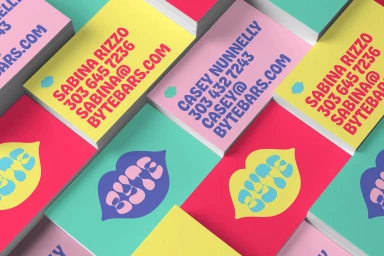 Stacks of colourful business cards featuring bold typography and lip logo graphics for Byte brand identity