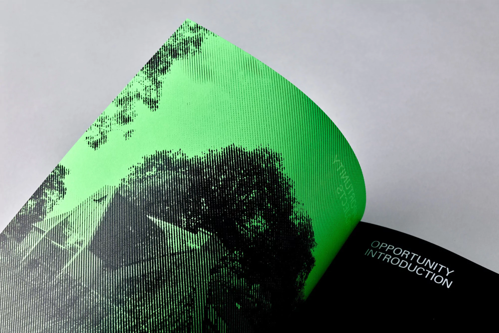 Two pages of a design document, one with a black and green graphic of a building, and another page with the words 'Opportunity Introduction'.