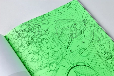 Bright green architectural site plan drawing printed on paper inside a bound book layout