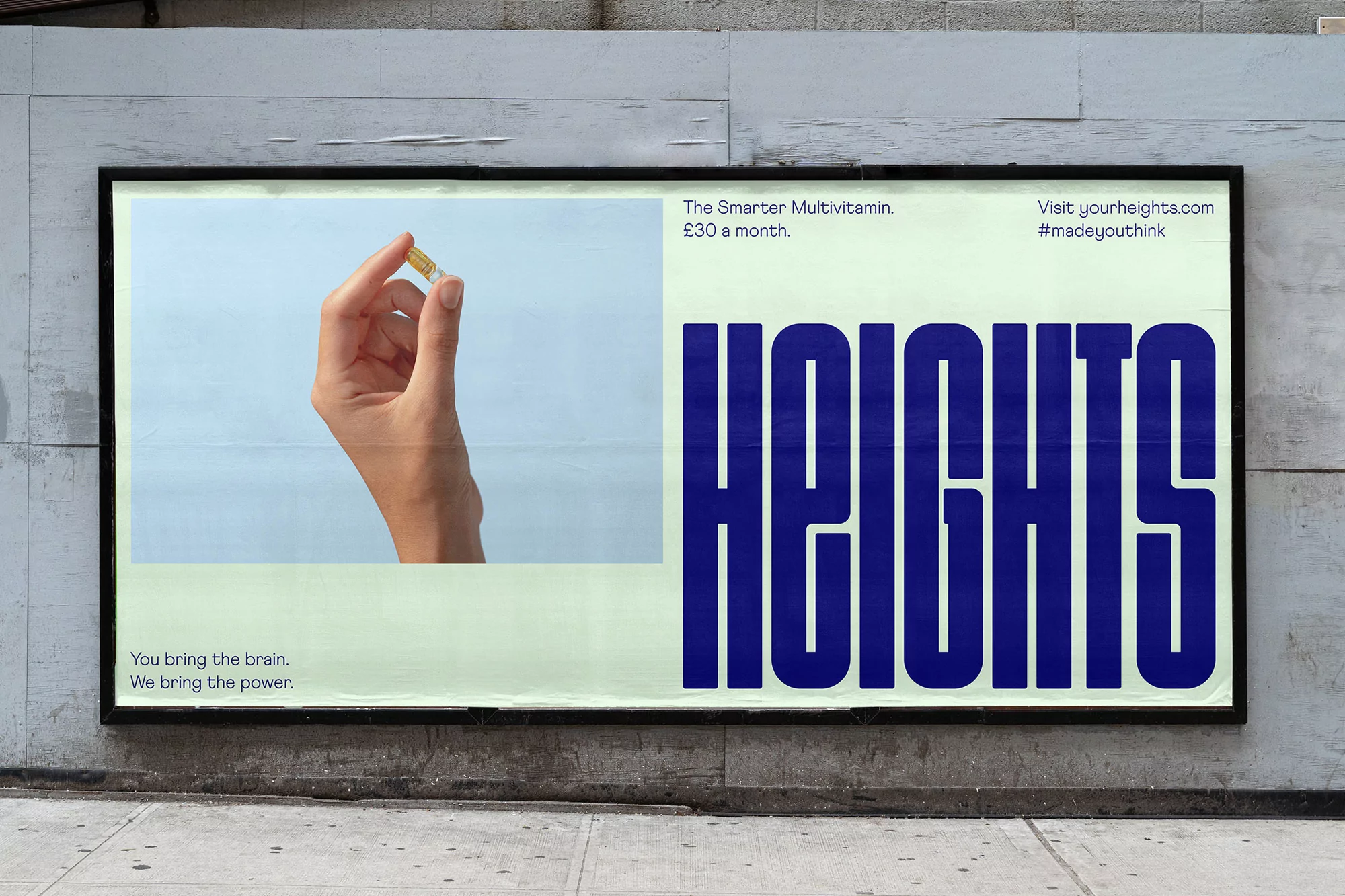 A billboard advertisement for Heights vitamins shows a person holding a pill in front of the company's vertically stacked logo on concrete.