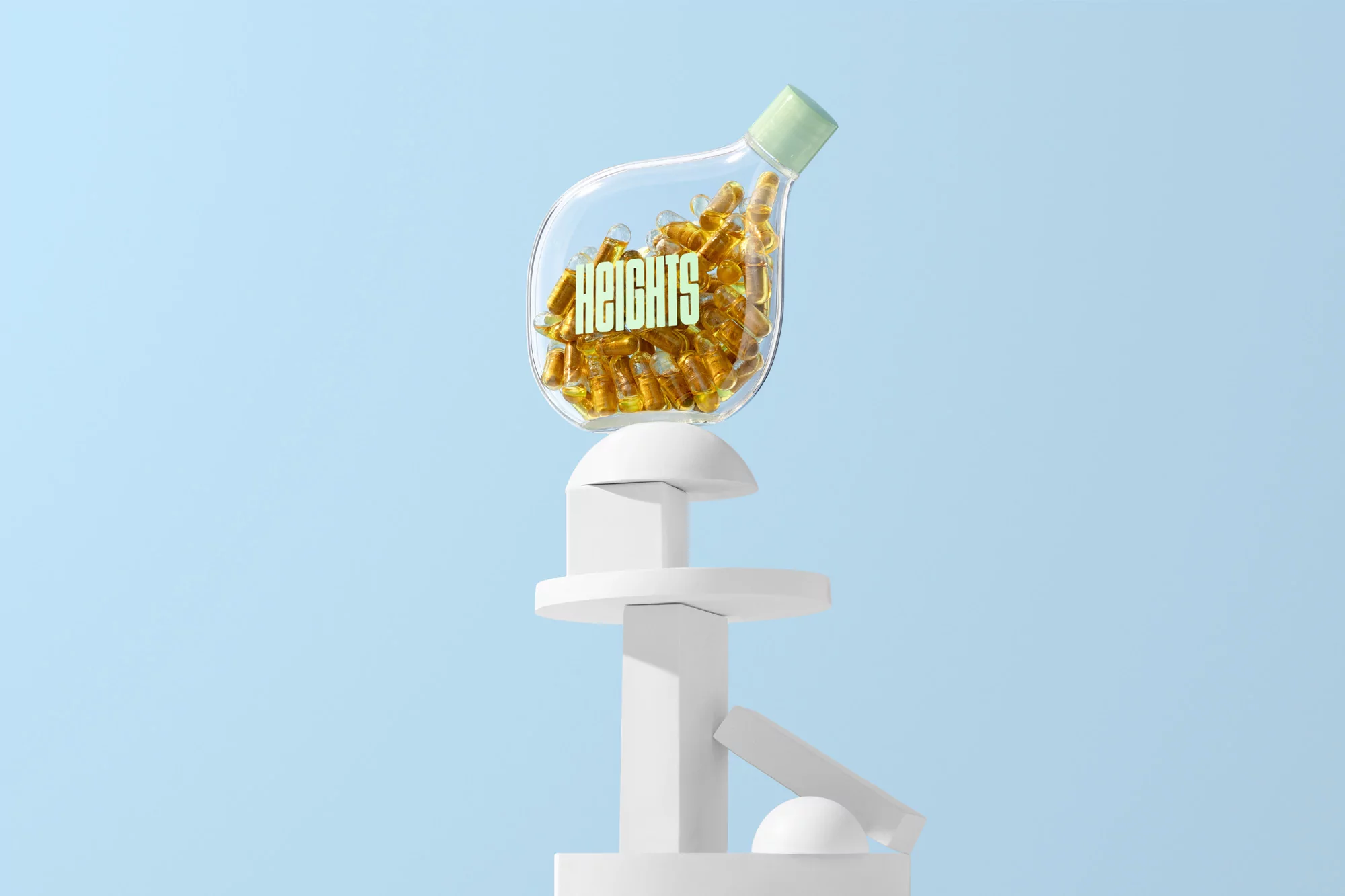Clear bottle of golden capsules with the word HEIGHTS on white geometric stand against a baby blue background in a studio shot.