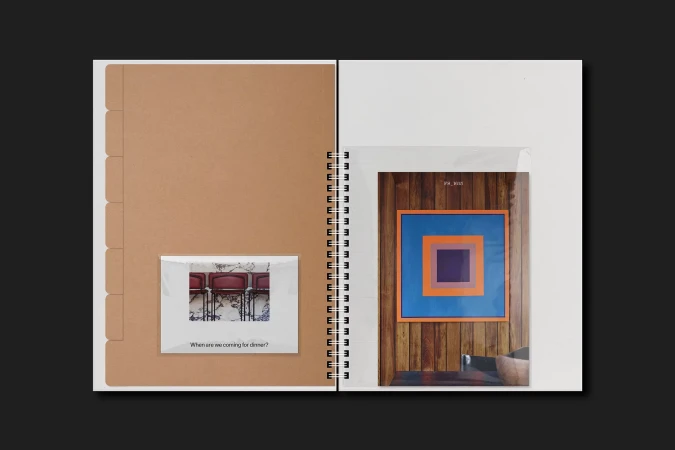 Open notebook displays photos: one of chairs and a dinner question, the other a color block print on a wooden wall. 