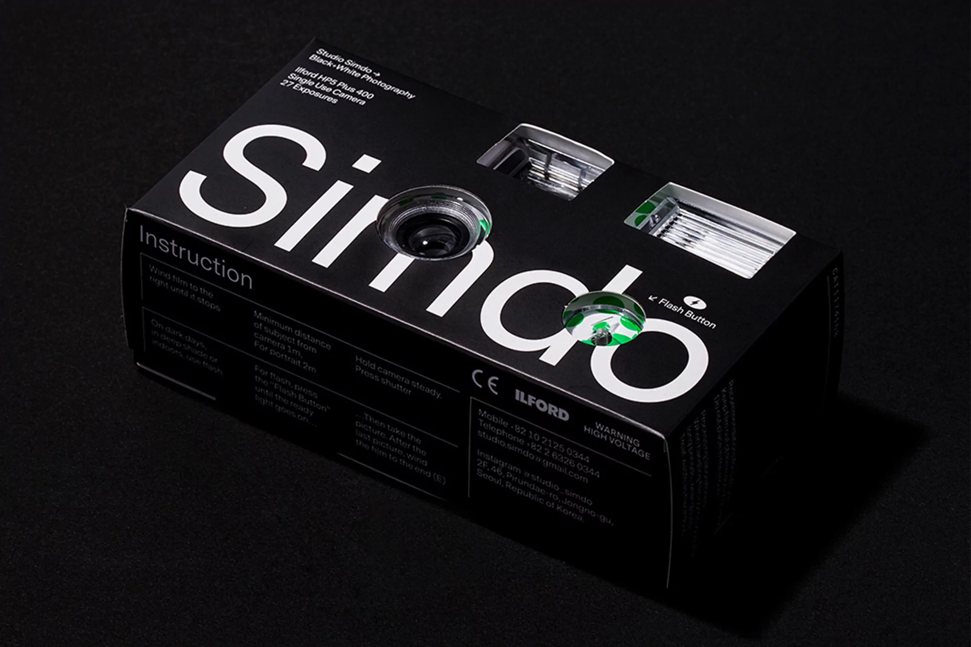 Black and white single use camera in its product packaging. Simdo branded disposable camera box on a dark grey background.