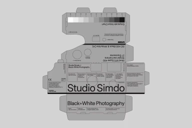 Unfolded flat packaging design for Studio Simdo camera featuring typography and grayscale value chart