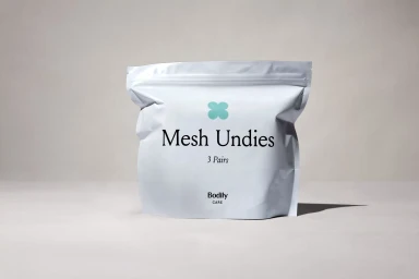 White product pouch labelled Mesh Undies with turquoise logo on neutral background
