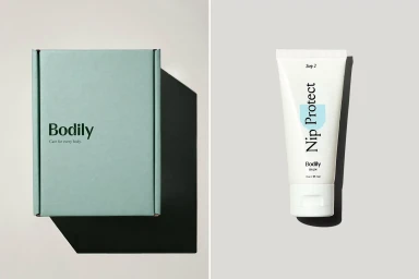 Green packaging box and white tube product with typography on a grey seamless studio background.