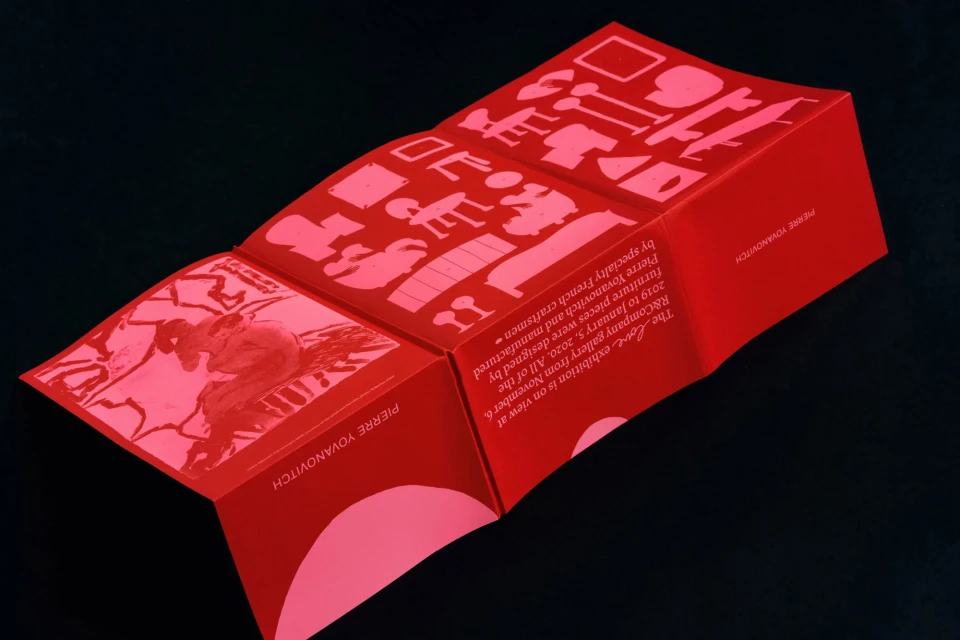 Promotional brochure for Pierre Yovanovitch R&Company gallery exhibition featuring furniture designs in red and white on black background.