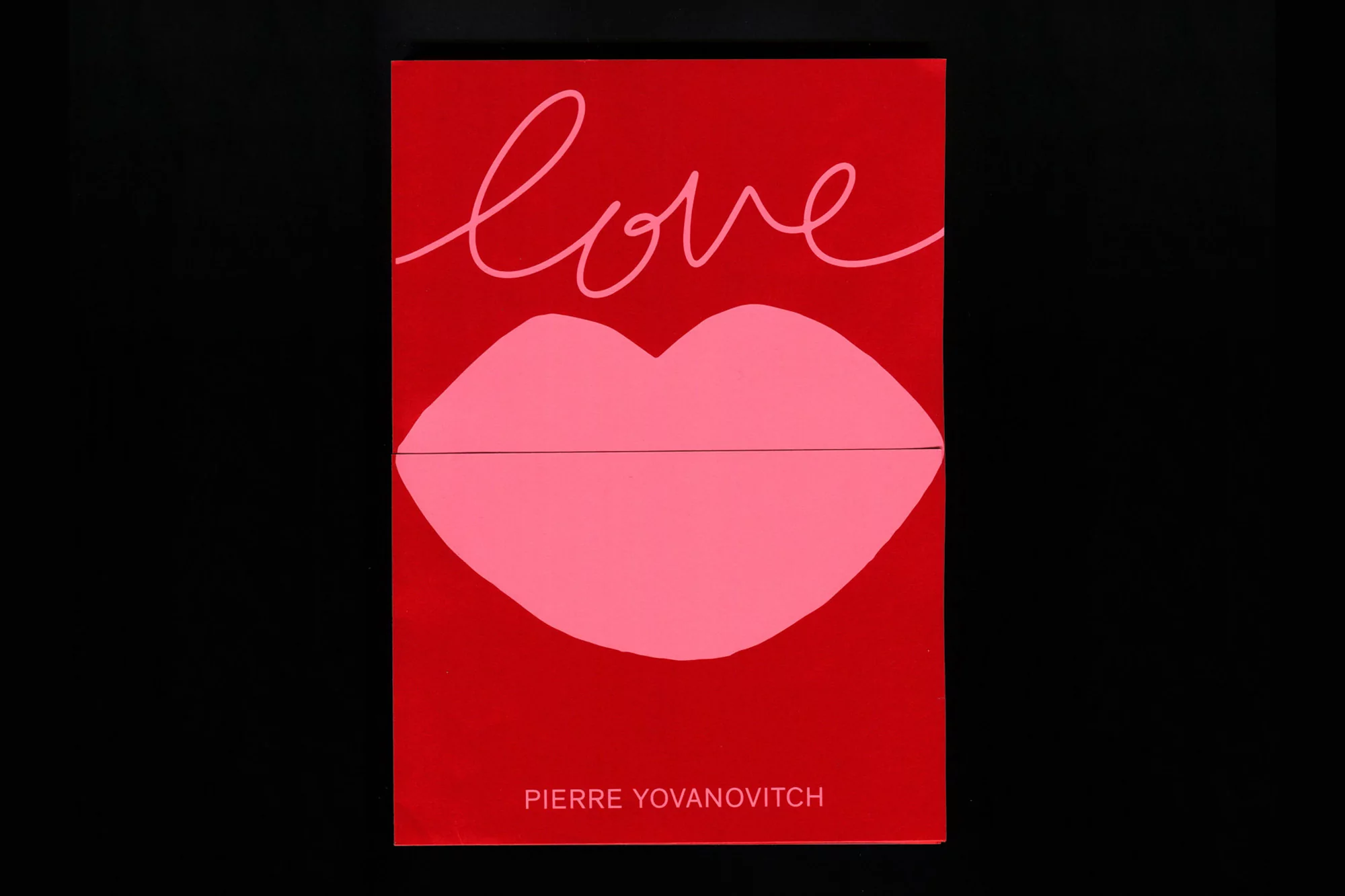 Abstract illustration on a red background featuring the word 'love' in script above an image of pink lips, with the name Pierre Yovanovitch.