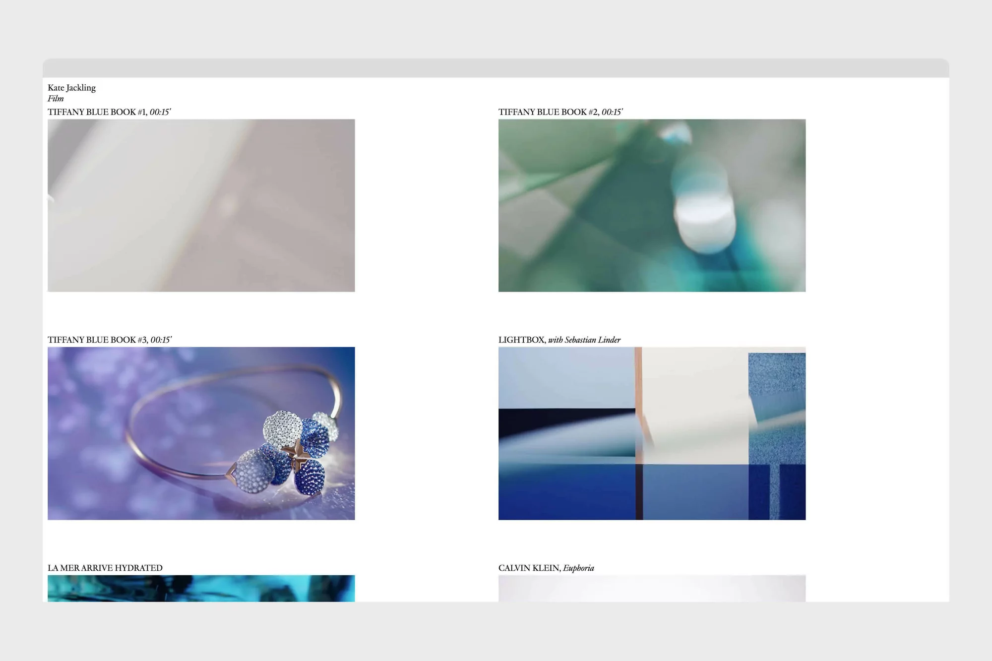 Abstract still life featuring close-ups of jewelry, gradients and colored blocks in blue and white, displayed on a white surface.