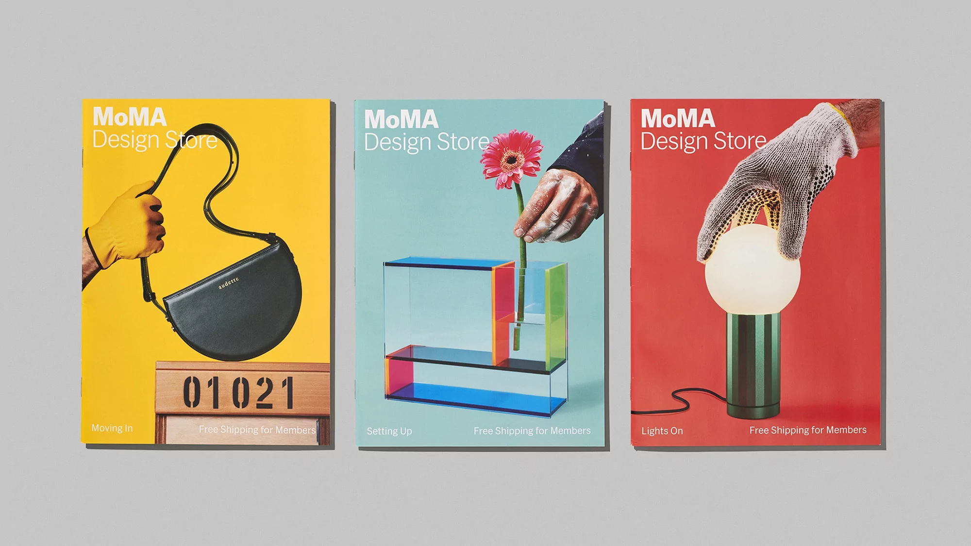 Three MoMA Design Store catalog covers: a purse with yellow gloves, a flower in a vase, and a lamp held by a mesh glove.