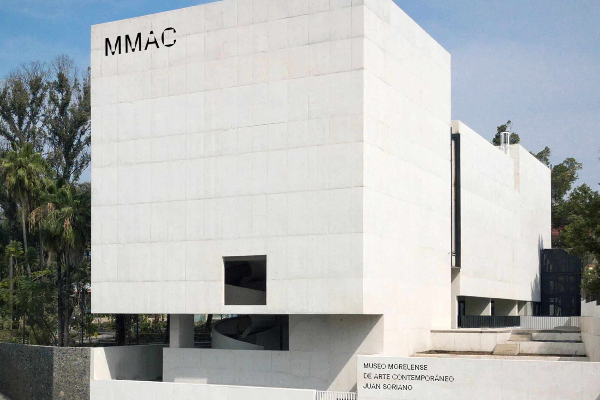 Exterior shot of the Museo Morellense de Arte Contemporáneo (MMAC) building showcasing modern architecture, white concrete, and geometric design.