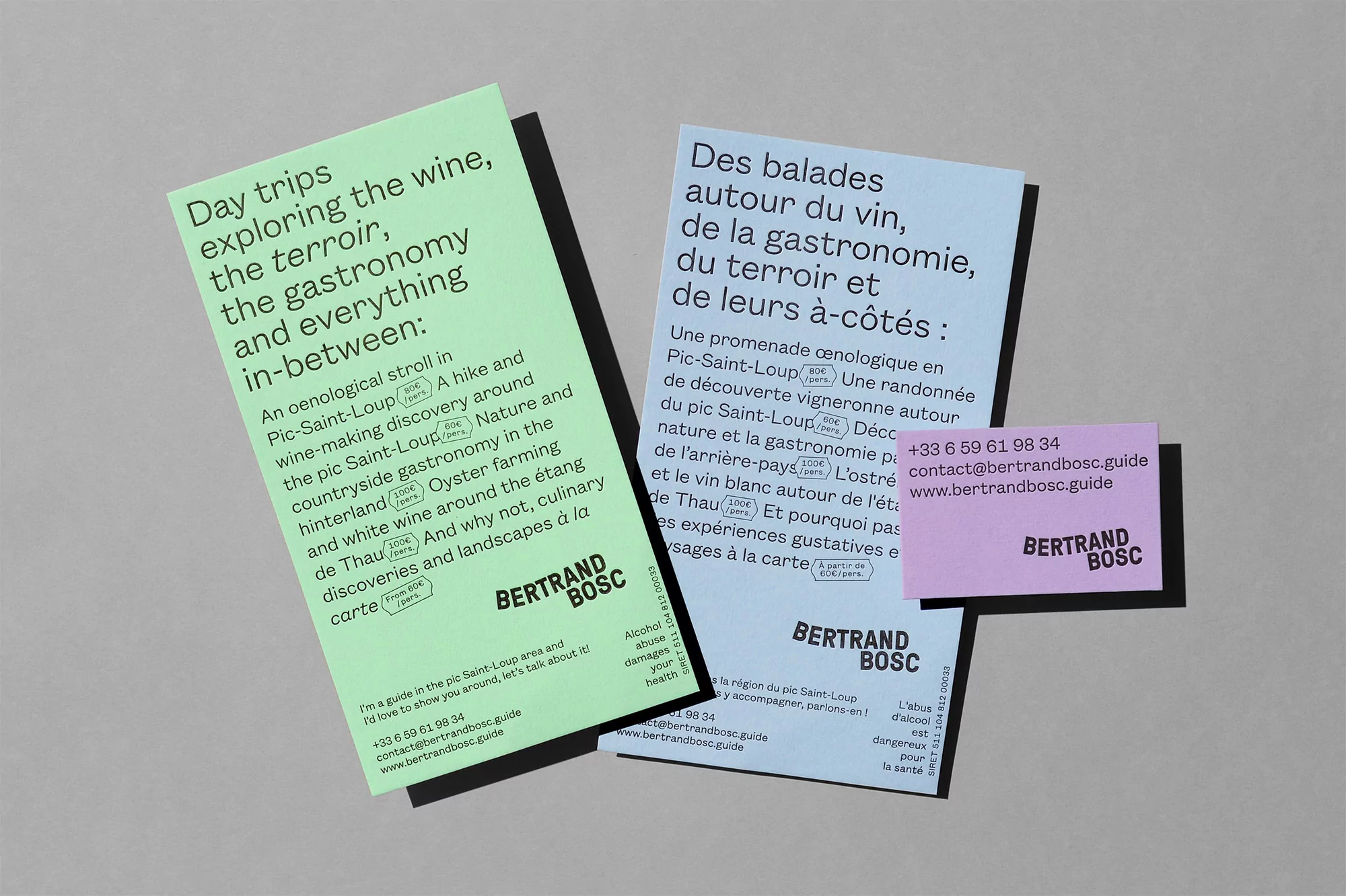 Informational brochures and business card with Bertrand Bosc branding about wine and gastronomy excursions, displayed on grey background.