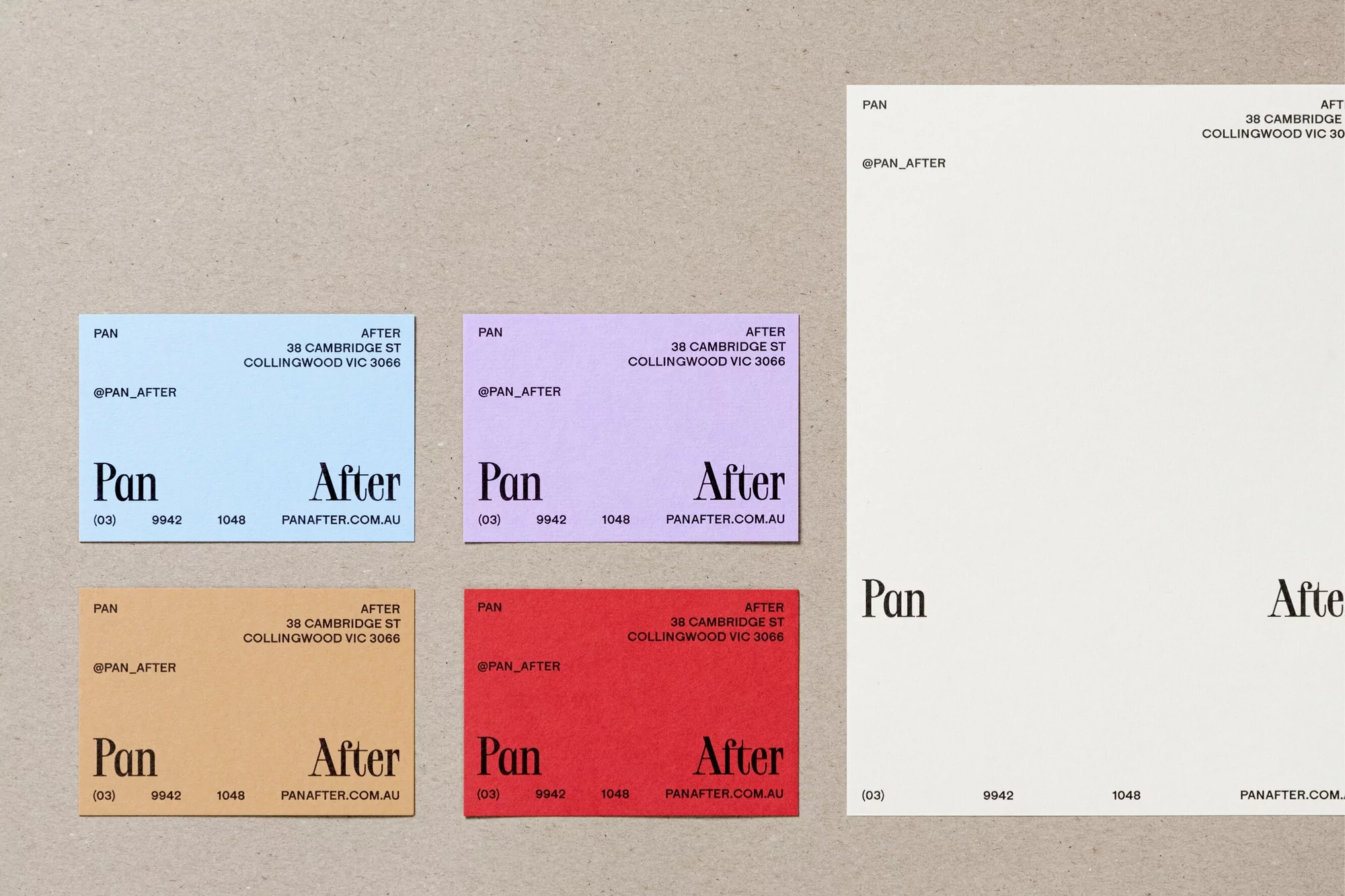 Various color business cards and a white card display the 'Pan After' logo and contact information, set on a neutral surface.