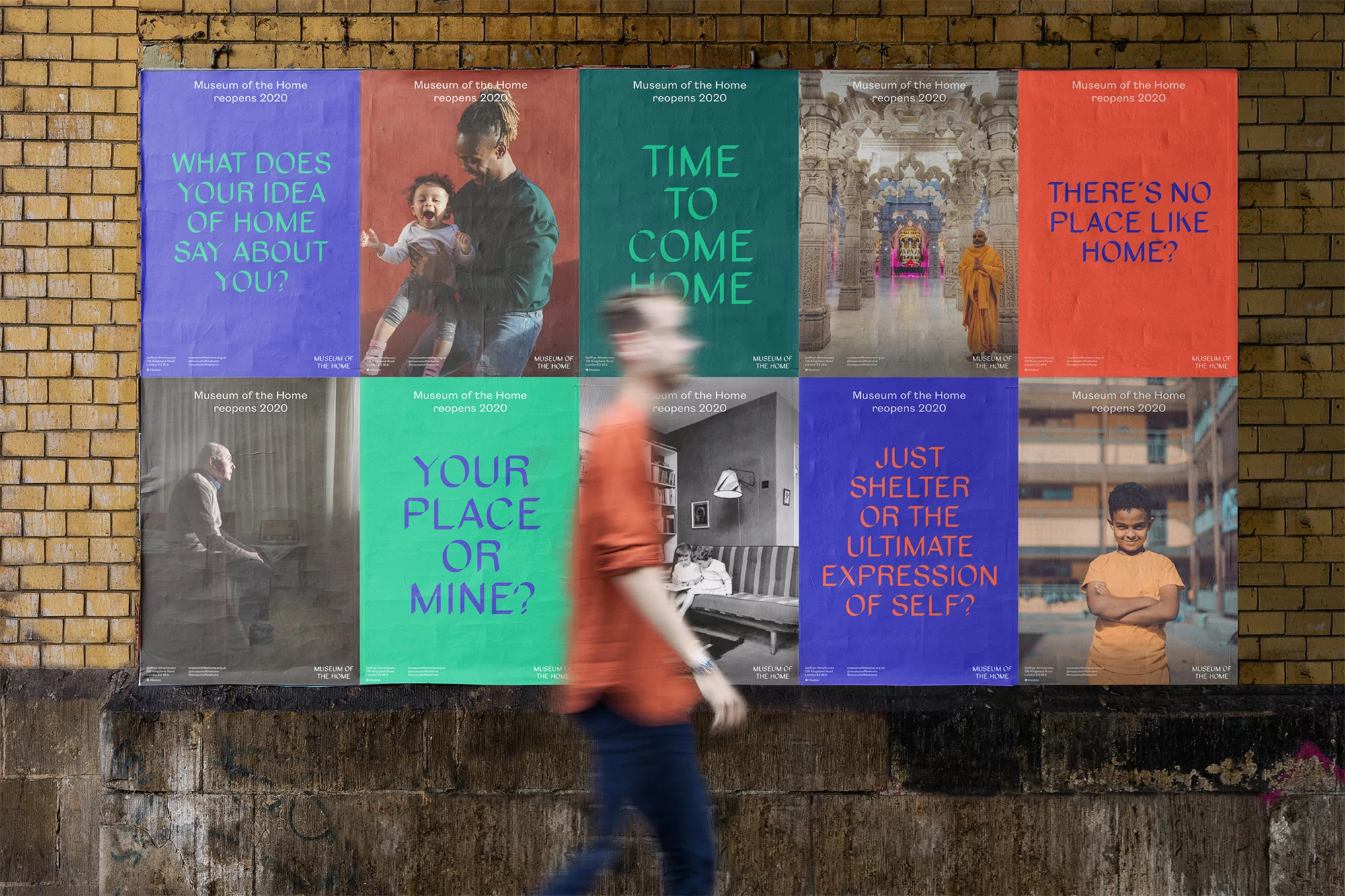 Museum of the Home advertisement posters on a brick wall featuring families, adults, and kids with the institution's reopening date of 2020.