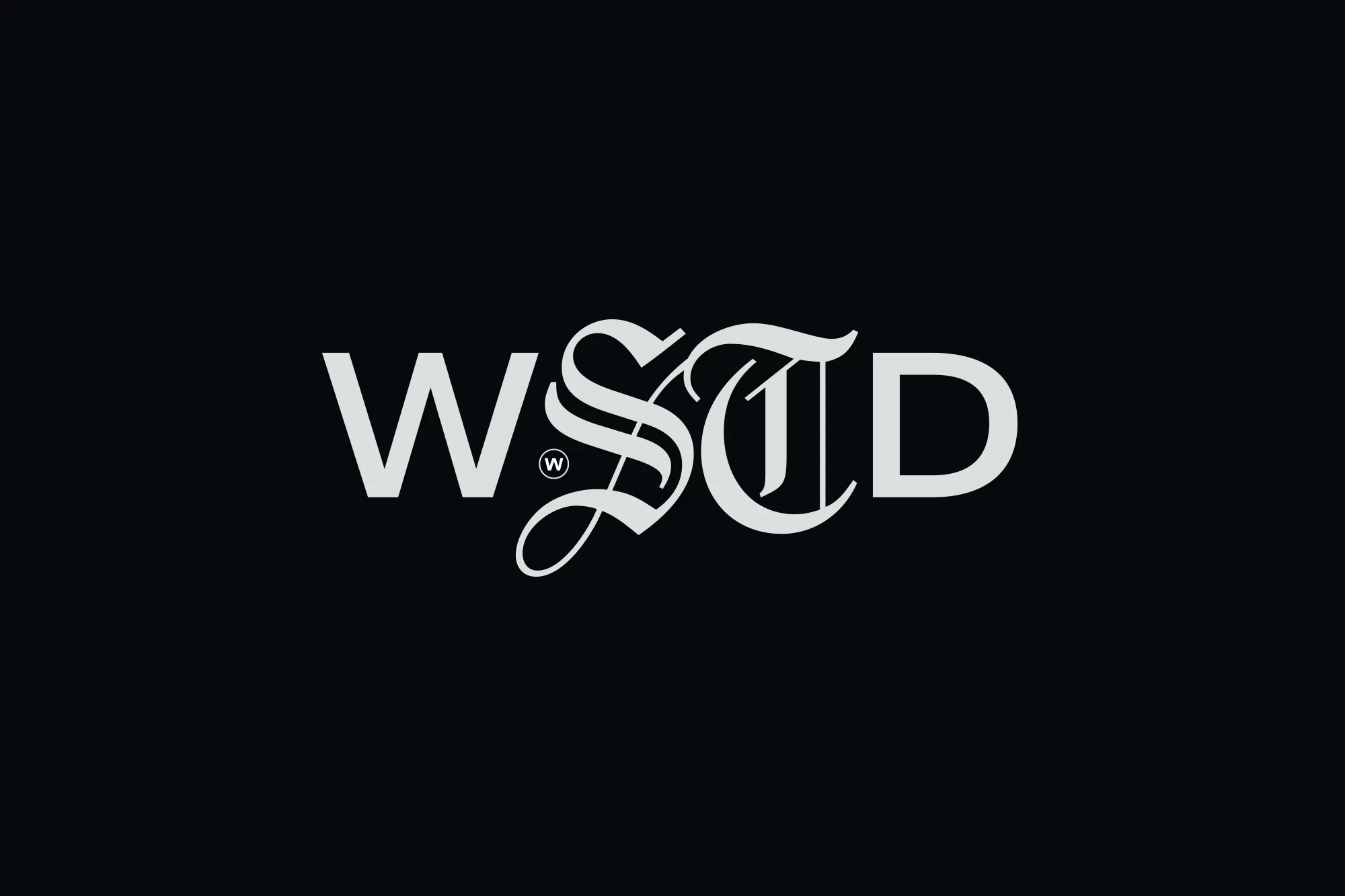 WSTD logo design in white against a black background. The font is ornate and stylized. Emblem for web, print and social media use.