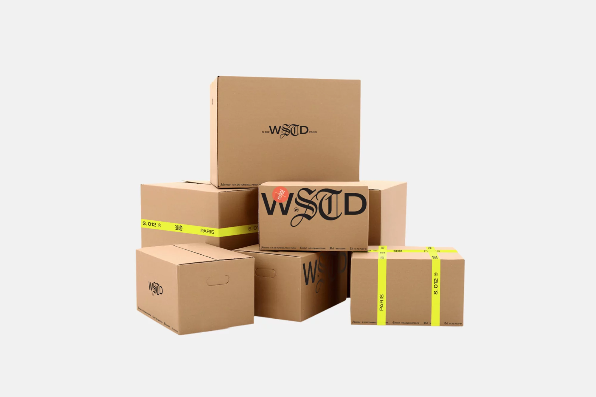 Stack of branded cardboard boxes with a logo and neon yellow tape isolated on a white background, shot in a photo studio.