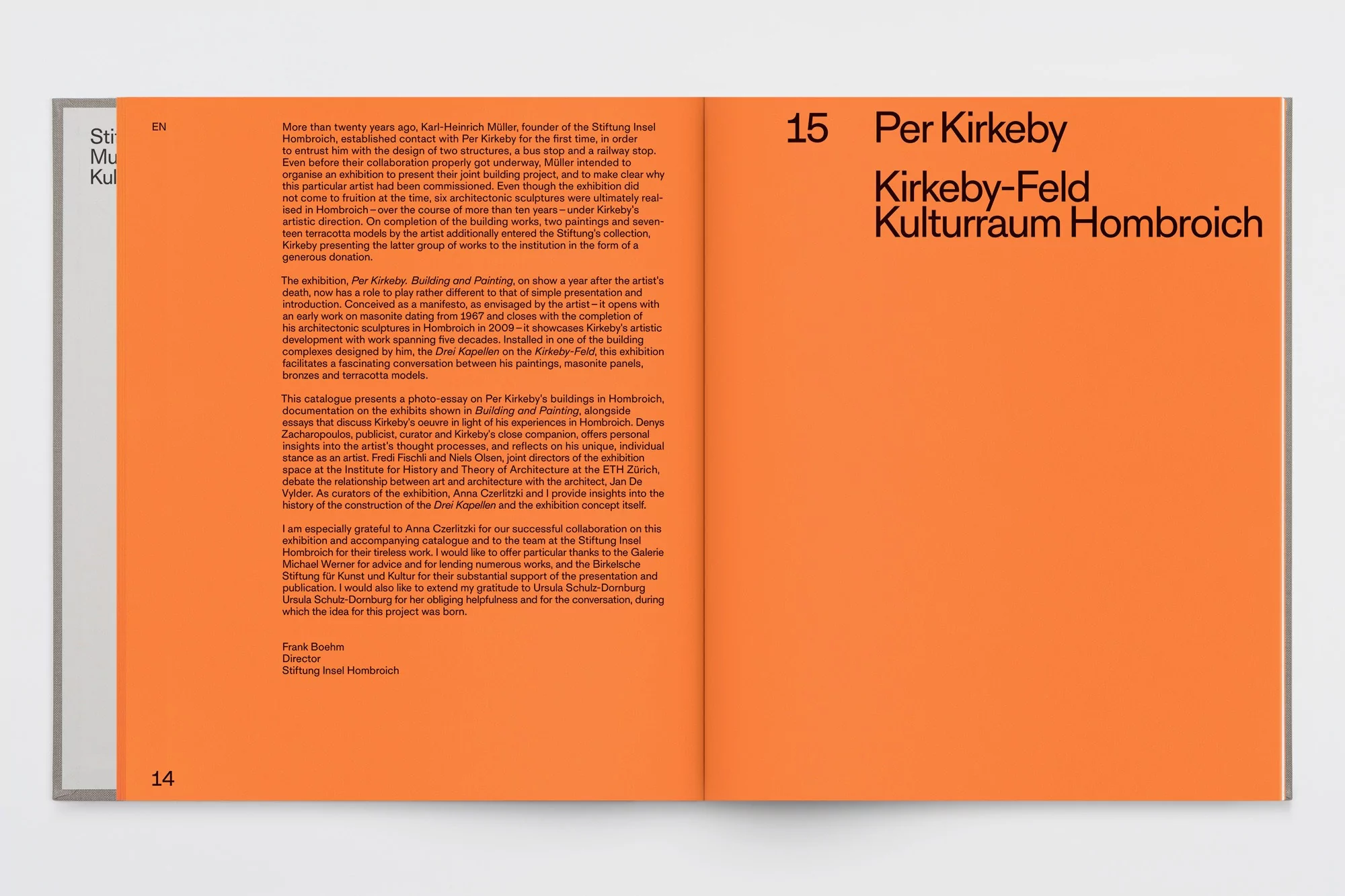 Open book layout featuring bold sans-serif typography set against vibrant orange pages for Stiftung Insel Hombroich brand identity design.