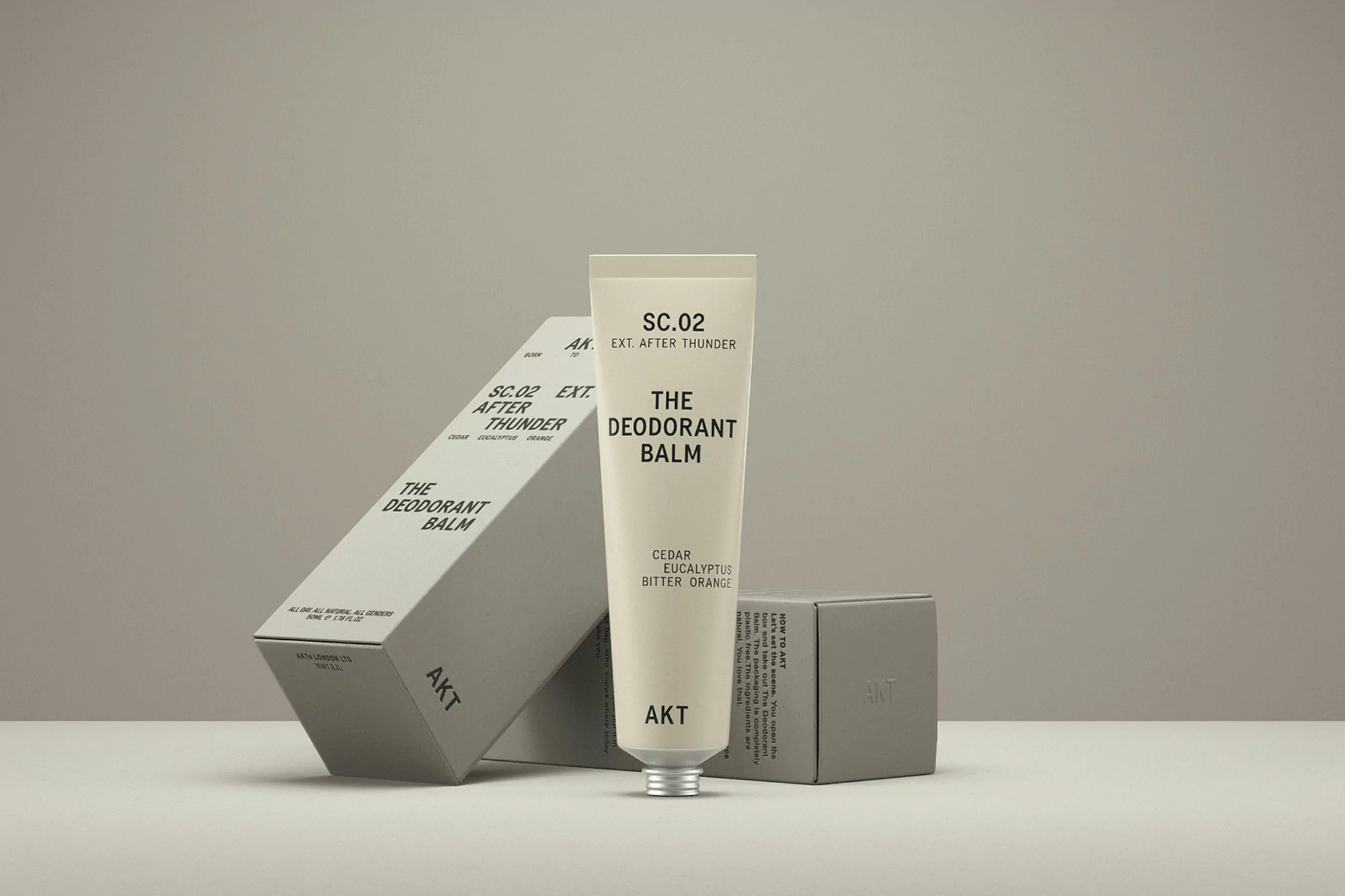 AKT deodorant balm and packaging featuring minimalist design and neutral color palette on a neutral background, product photography.