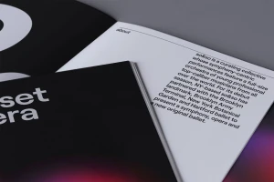 Close-up of a printed booklet with minimal sans-serif typography on white and black pages