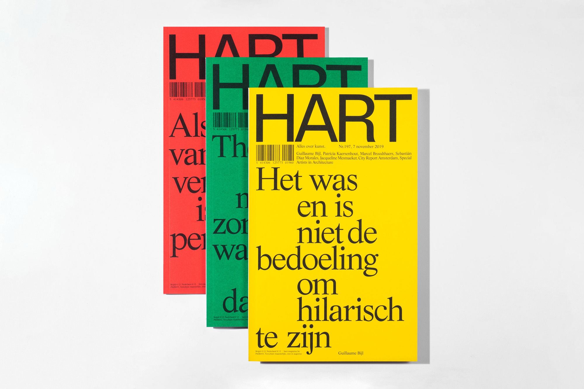 Three art magazines with red, green, and yellow covers, featuring large sans-serif typography on a plain white background in a studio setting.