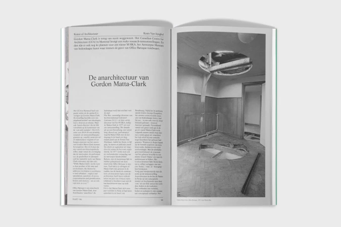 A black and white open book spread showcases an image of an interior under construction with exposed beams and damaged ceilings and floors.