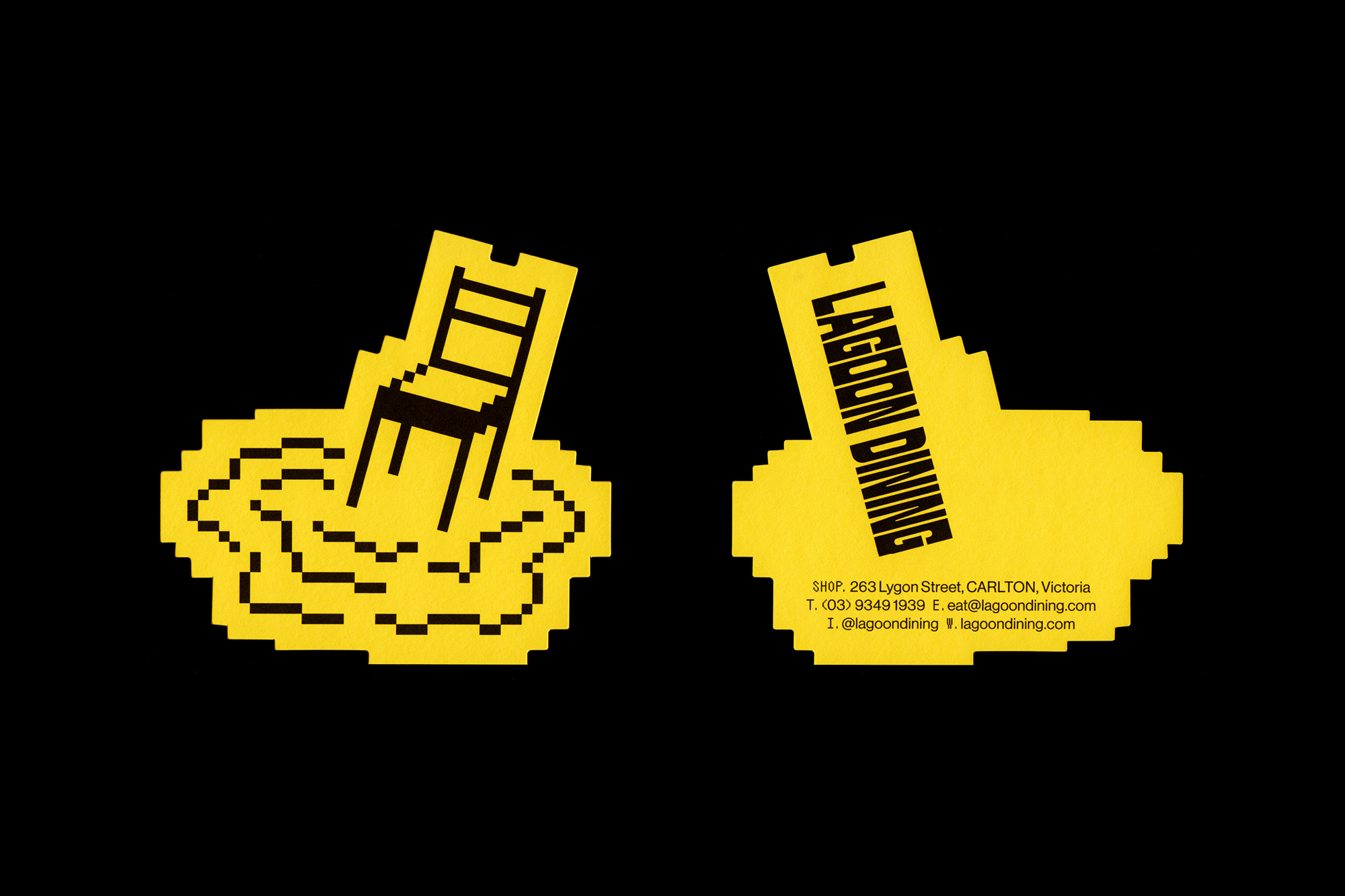 Illustration of two yellow business cards against a black background: one with a chair and one with the words Lagoon Dining.