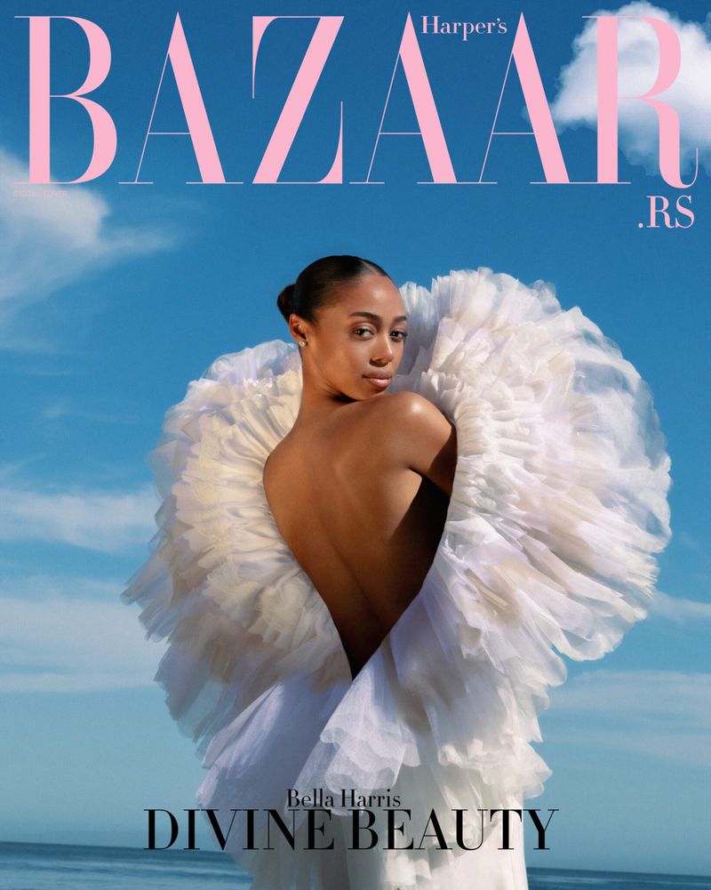 Harper's Bazaar cover featuring Bella Harris wearing white tulle gown against a sky and ocean background.
