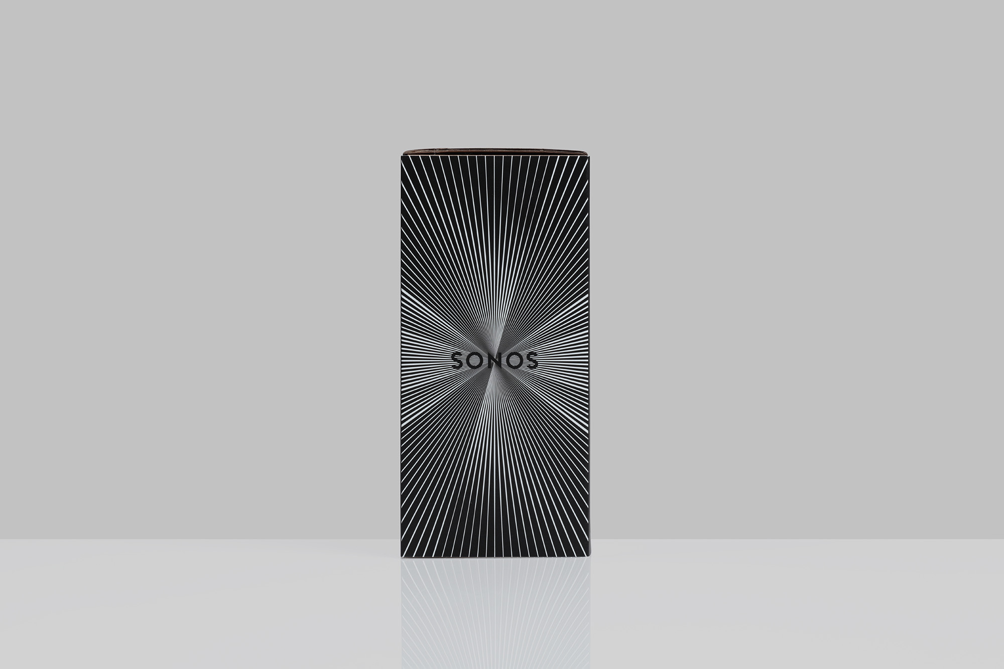 Sonos product box featuring a black background and an abstract radial design with thin white lines converging toward the center.