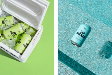 Sapsucker sparkling water cans in an ice-filled cooler and a single blue can resting on a turquoise pool edge.
