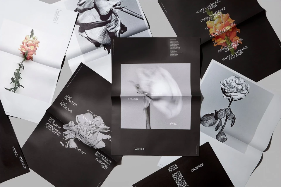 Graphic design featuring black and white floral posters arranged on a light gray surface with visible text and dates, conveying a minimalist style.