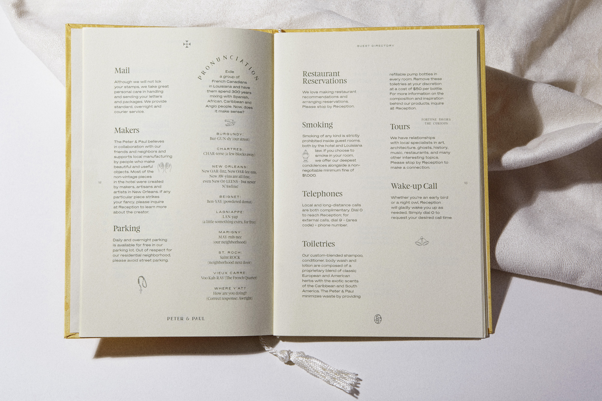 Open guest directory on a white surface with information about the hotel's amenities such as dining, tours and concierge services.