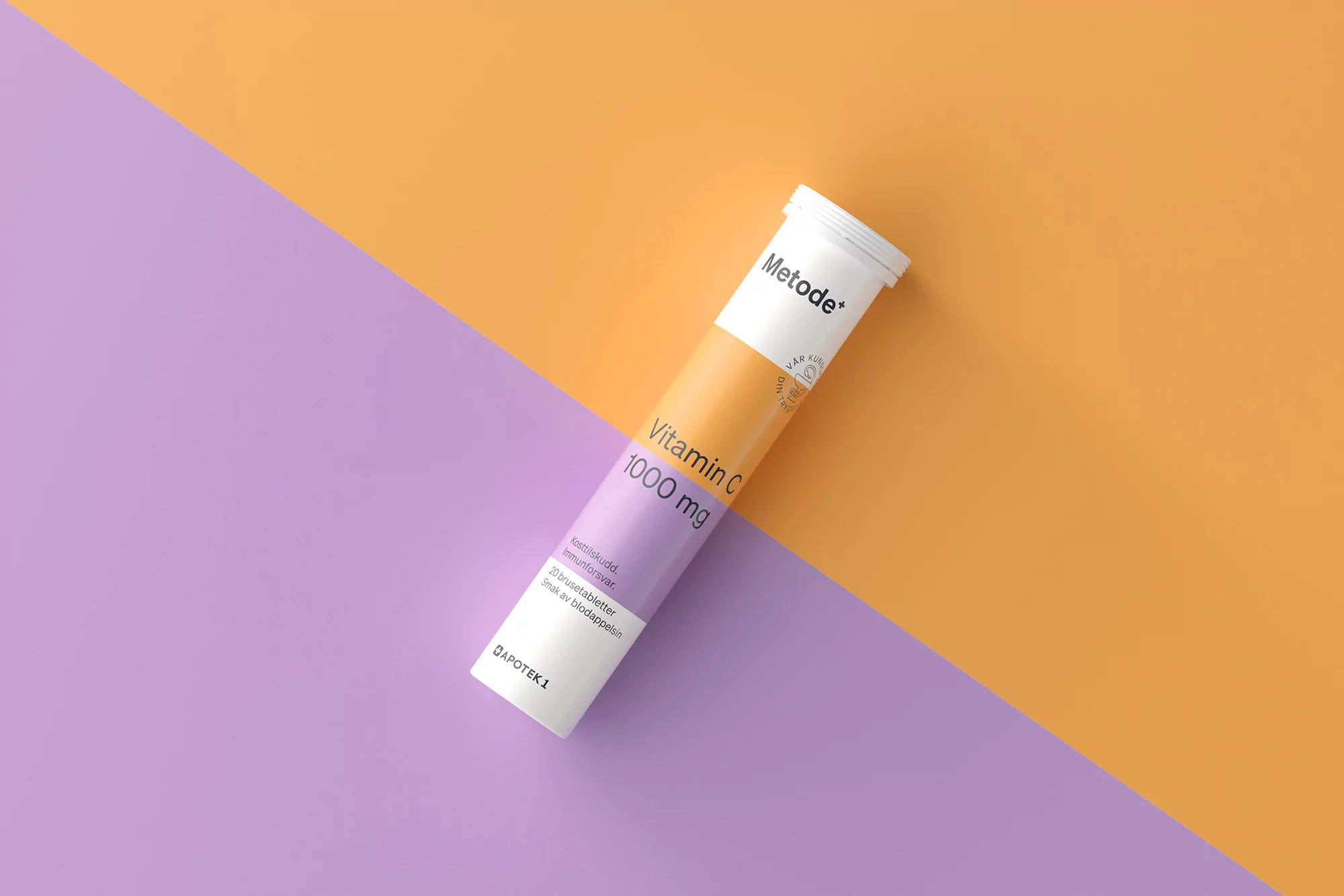 Tube of Metode+ Vitamin C 1000 mg effervescent tablets on a split background of purple and orange, product shot, studio lit.