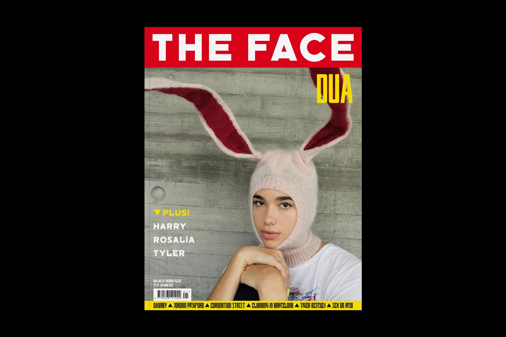 Magazine cover featuring a fair-skinned person wearing a pink knit balaclava with bunny ears, set against a concrete background.