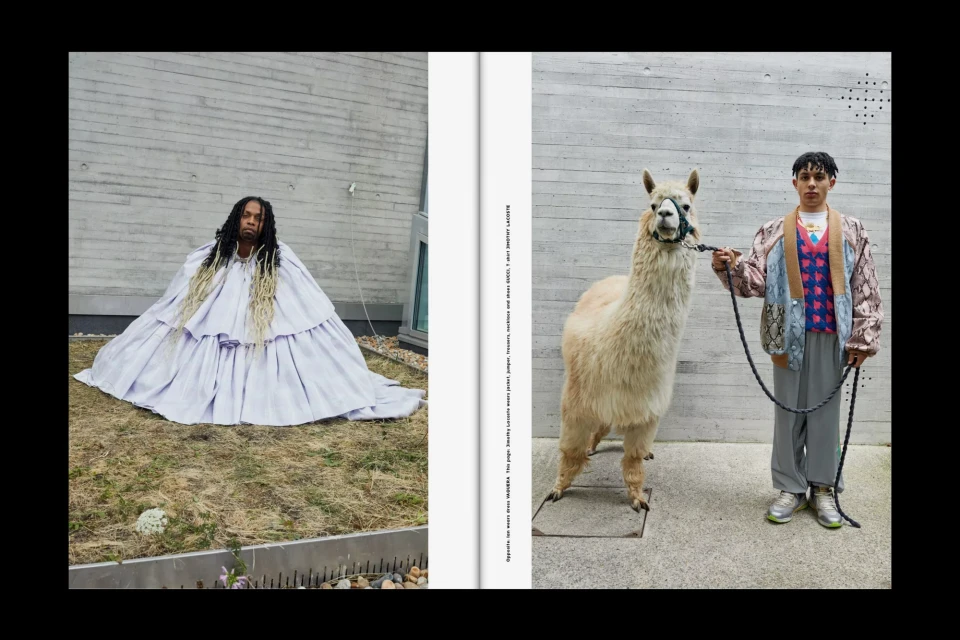 Editorial fashion shot with a person in a long gown sitting in front of a wall, and another person with an alpaca on a leash.