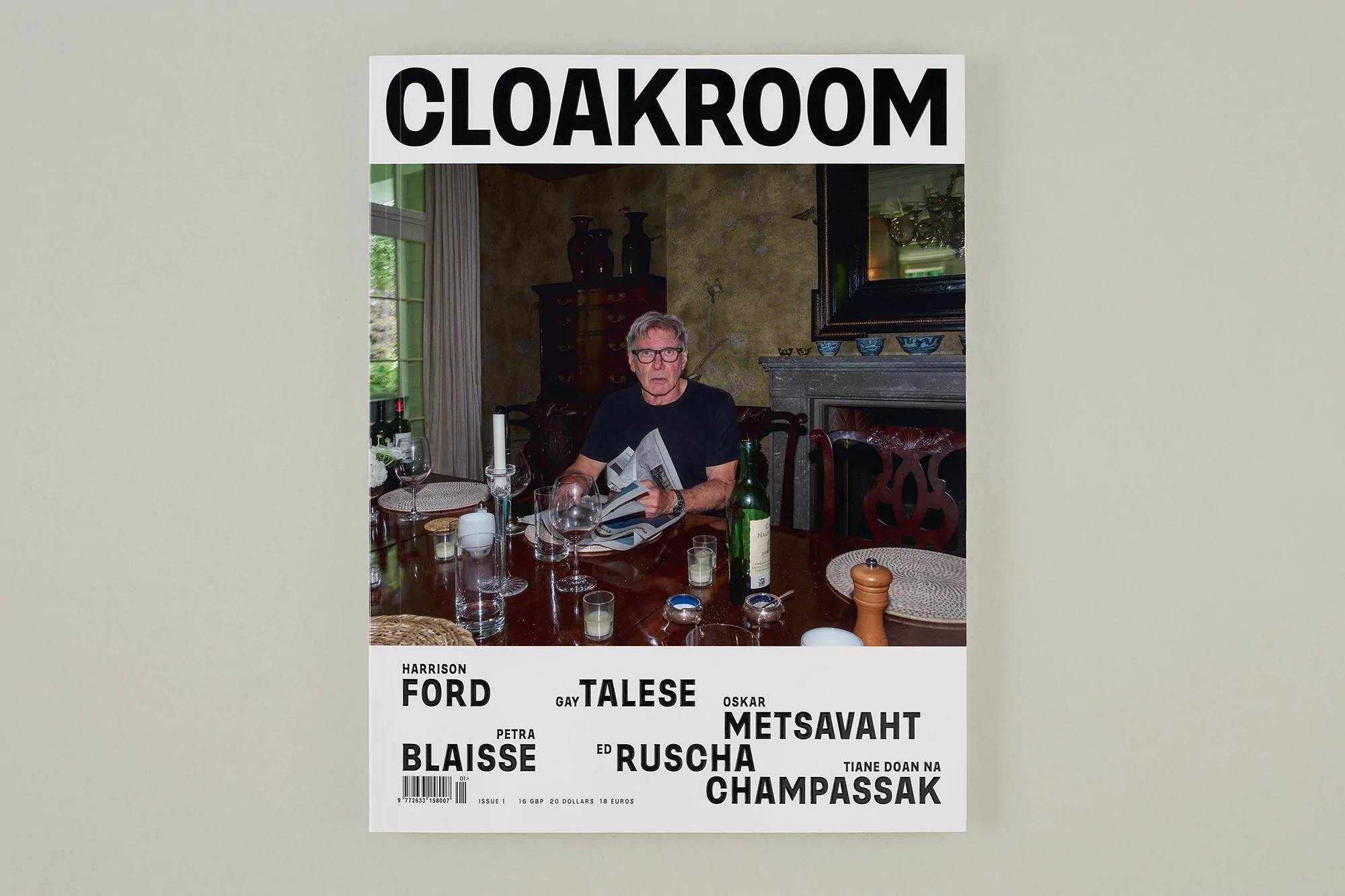 Magazine cover featuring Harrison Ford sitting at a dining table, holding a newspaper, in an indoor setting. Published by Cloakroom.