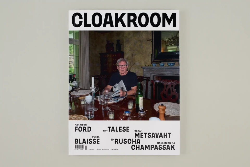 Magazine cover featuring Harrison Ford sitting at a dining table, holding a newspaper, in an indoor setting. Published by Cloakroom.