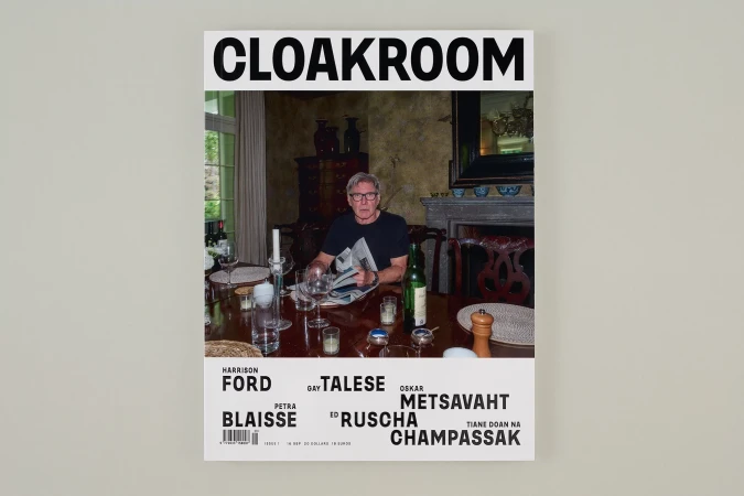 Magazine cover featuring Harrison Ford sitting at a dining table, holding a newspaper, in an indoor setting. Published by Cloakroom.