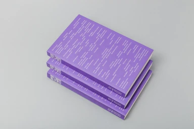 Three purple paperback books stacked diagonally on a neutral grey background displaying typographic covers for Porto City Theatre.