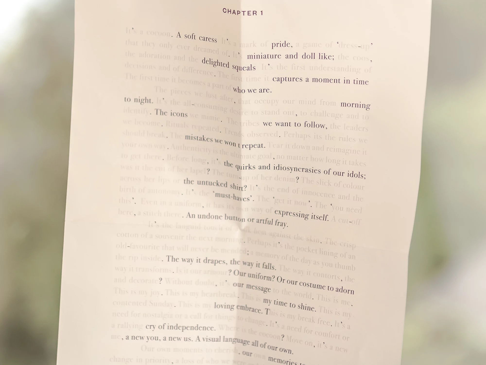 Open book page with the beginning of Chapter 1 filled with text, focusing on themes of identity, memories, and personal expression.