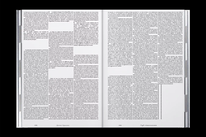 Open book displays text on both pages, illuminated against a dark background, showcasing book design and typography elements.