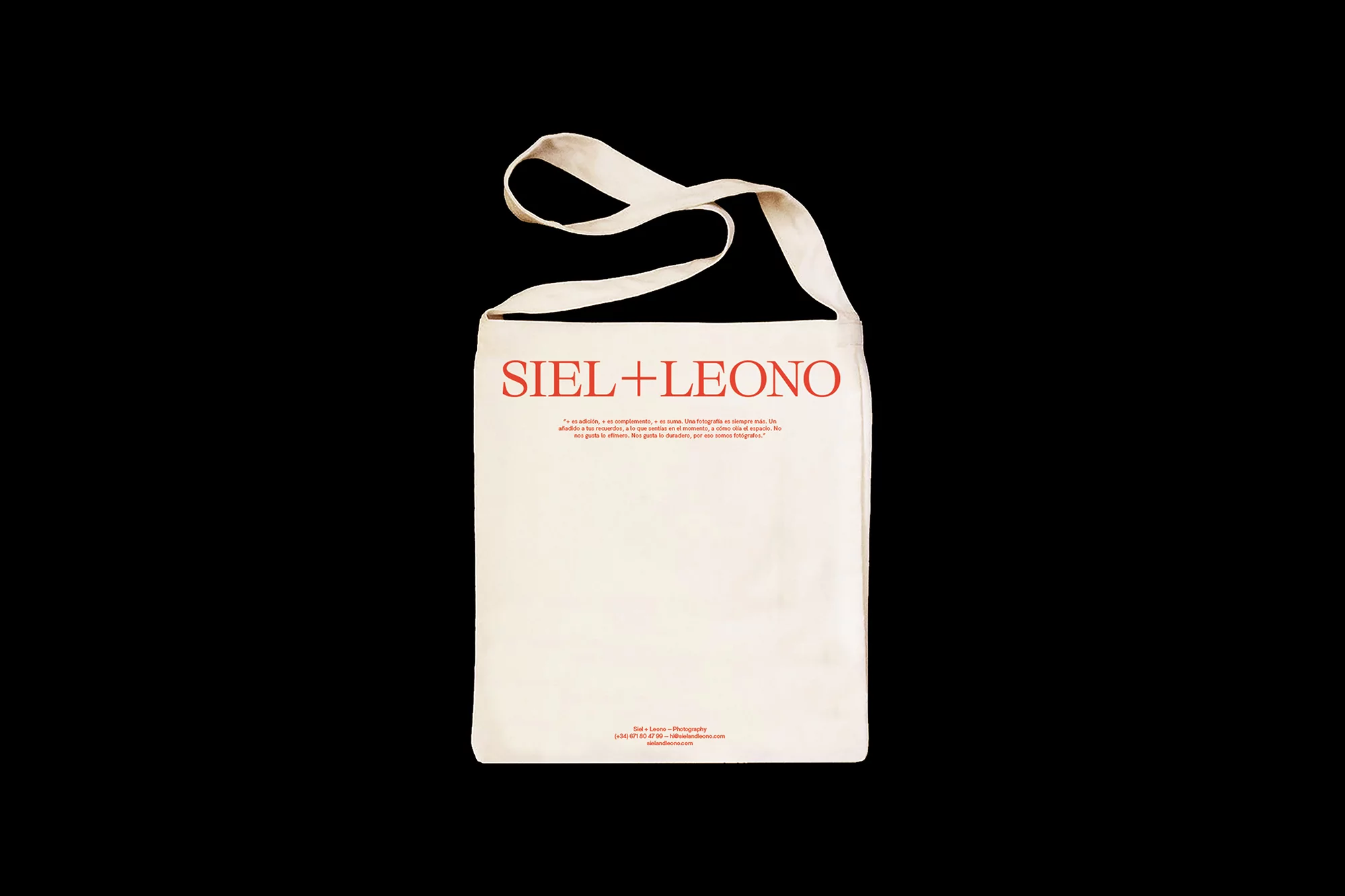 White tote bag featuring the brand name SIEL+LEONO in red lettering. The background is solid black.  Studio photography, product shot.