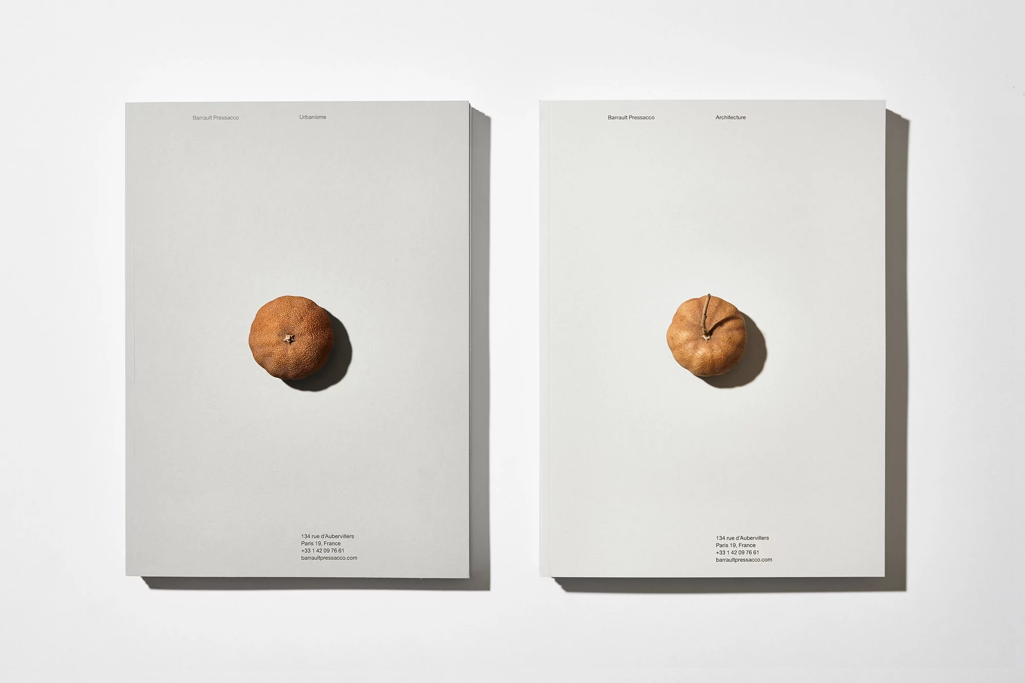 Two hardcover books titled 'Urbanisme' and 'Architecture' feature a small, dried fruit centered on each cover against a bright white background.