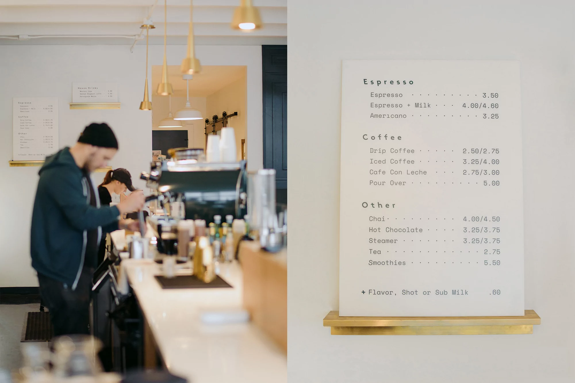 Inside a brightly lit coffee shop, an adult male barista works behind the counter as a menu board displays prices for drinks.