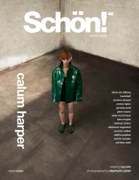 Model Calum Harper wearing a glossy green jacket standing in an industrial room shot from above for Schön Magazine