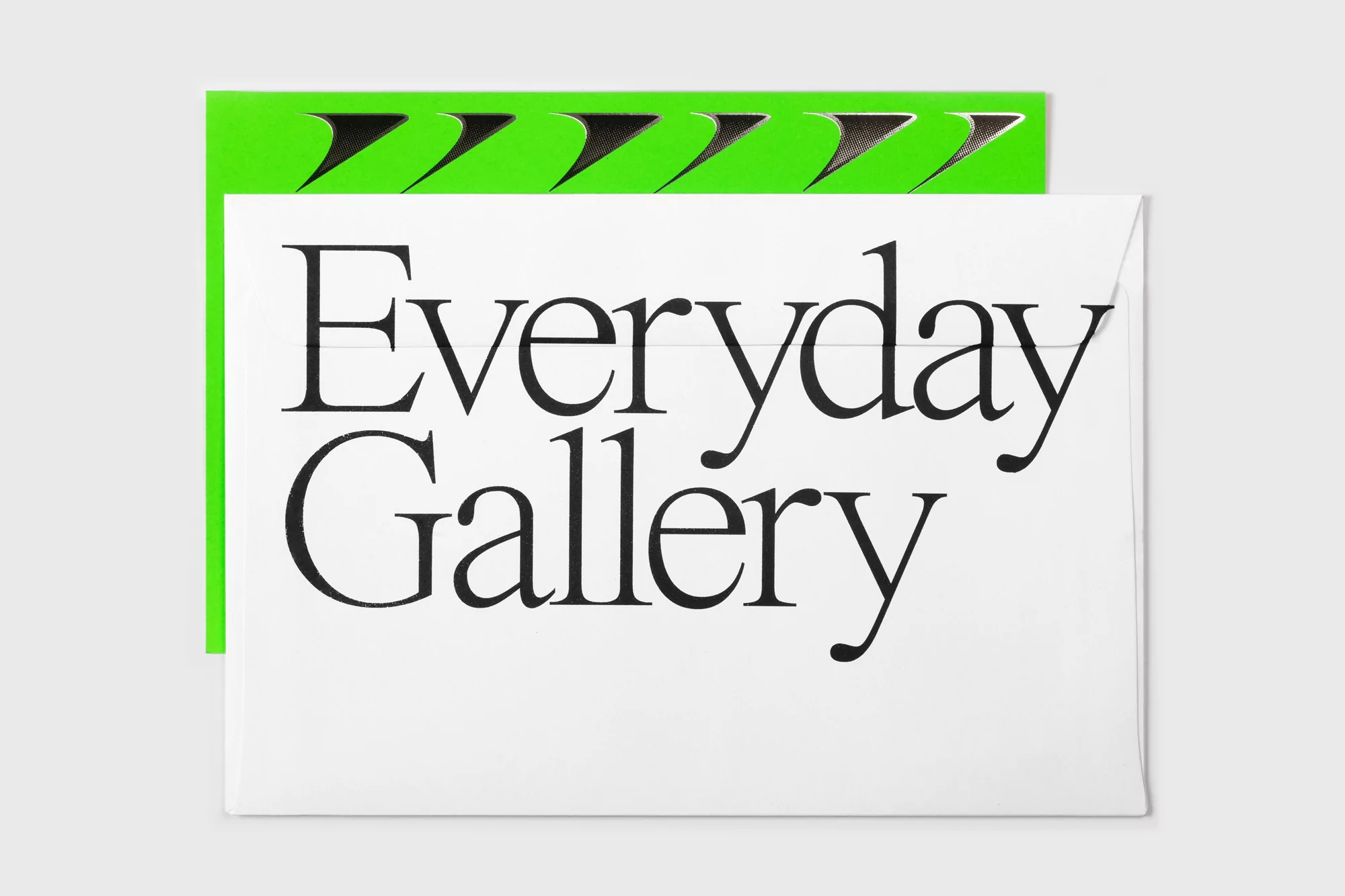 Envelope with 'Everyday Gallery' text and green graphic design element against a neutral background.