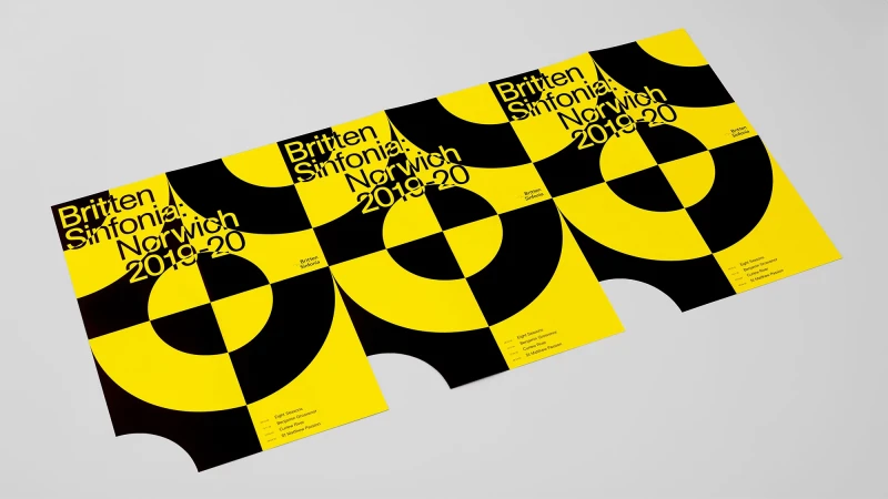 Three identical posters for the Britten Sinfonia Norwich 2019-20 season, featuring a yellow and black target-like graphic design.