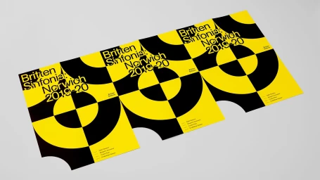 Three yellow and black printed concert posters featuring bold typography on a plain white background
